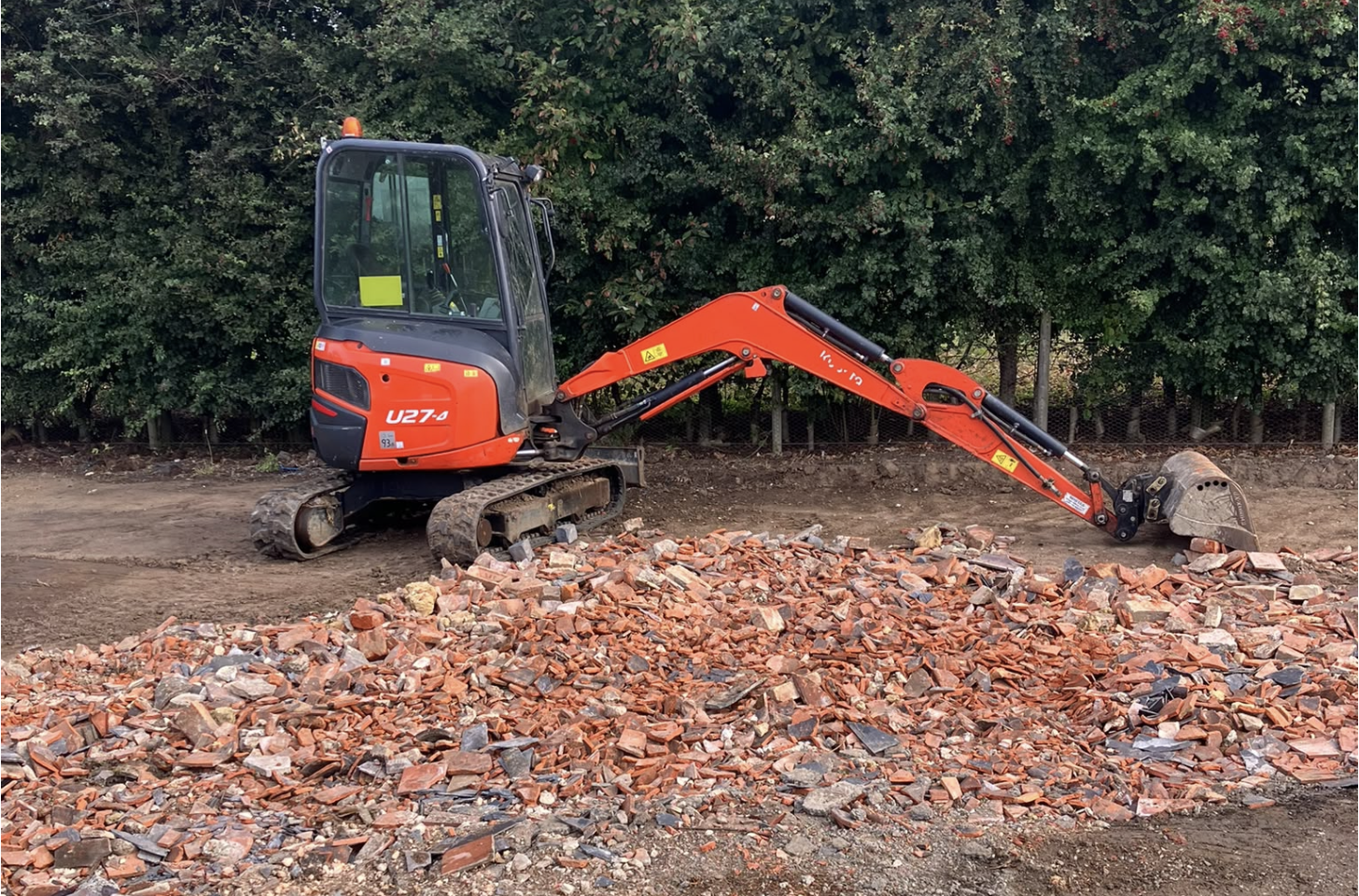 Orange tracked digger on a groundworks site