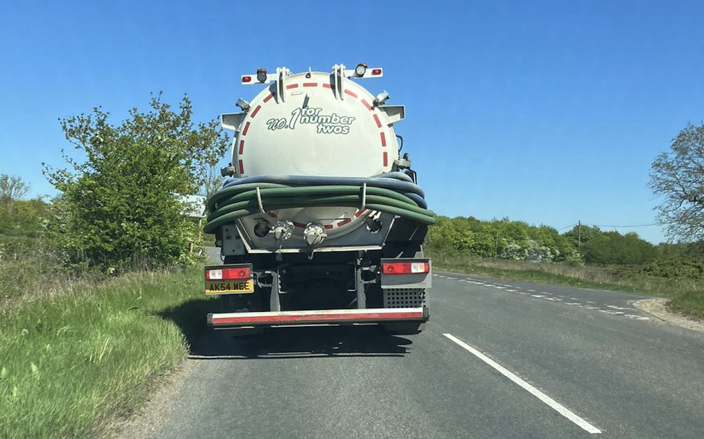 Rear view of an AK Services tanker on a country road